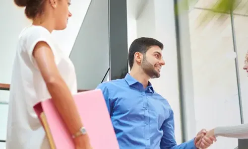 Business Entrepreneurship Bachelor Degree Program Graduate Shaking Hands with Operations Manager